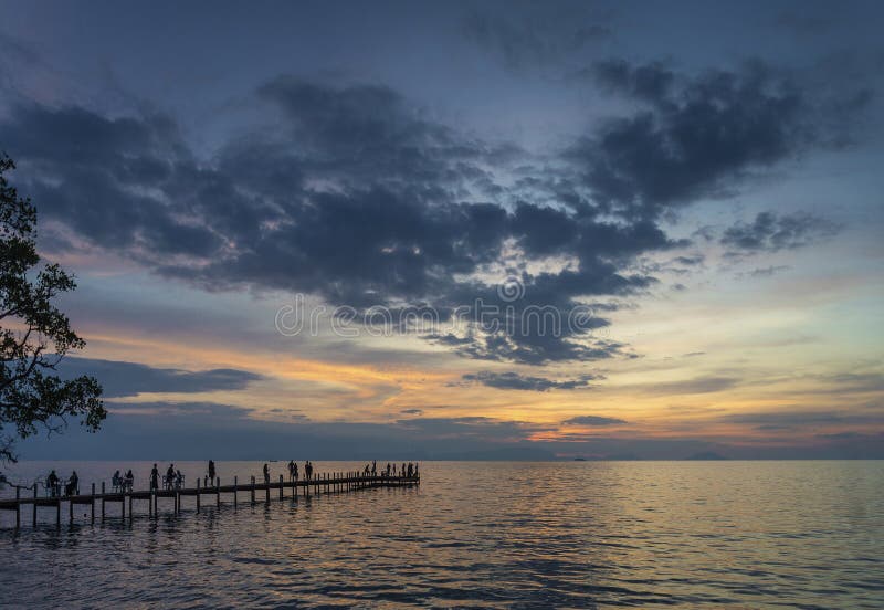 Tourists view sunset by pier in kep town cambodia coast