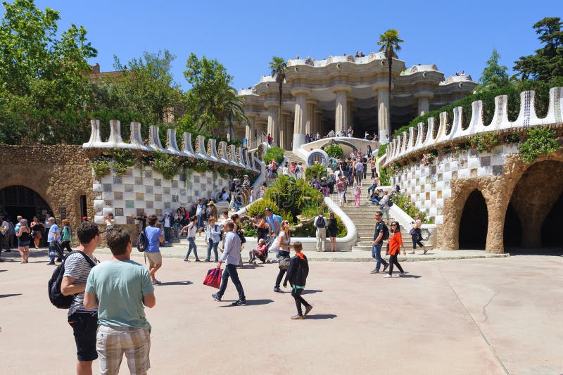 BARCELONA, SPAIN - MAY 2017: Tourists are visiting beautiful art objects at Park Guell in Barcelona, Spain.