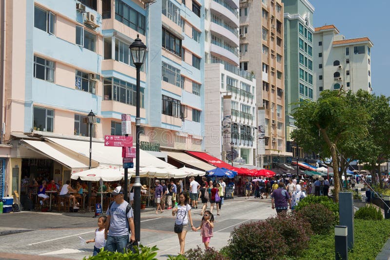 Tourists walk by the sea side street in Stanley town in Hong Kong, China. royalty free stock photos Tourists walk by the sea side street in Stanley town in Hong Kong, China. royalty free stock photos