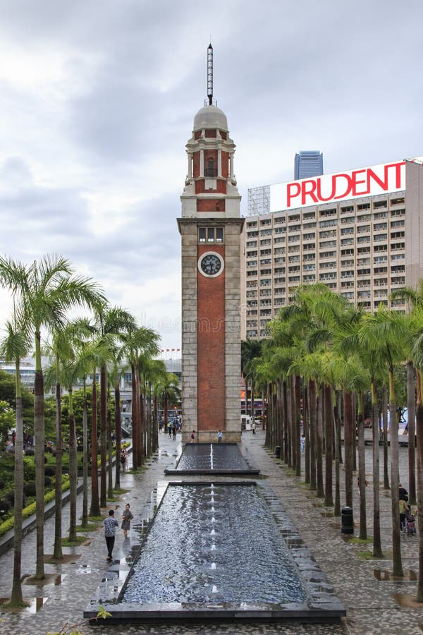 Tourists walking around the Clock Tower of Kowloong island, one of the landmarks of Hong Kong stock image Tourists walking around the Clock Tower of Kowloong island, one of the landmarks of Hong Kong stock image