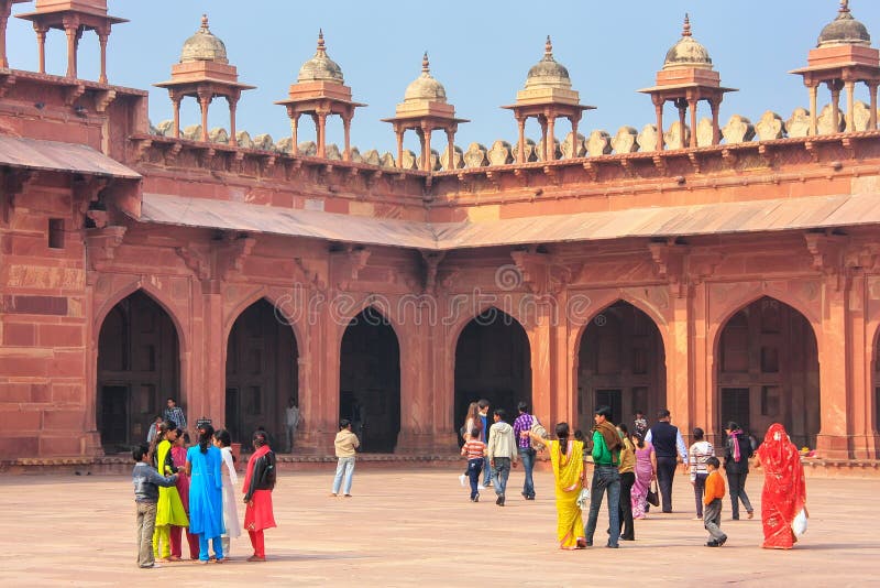 Tourists walking in the courtyard of Jama Masjid in Fatehpur Sikri, Uttar Pradesh, India. The mosque was built in 1648 by Emperor Shah Jahan and dedicated to his daughter Jahanara Begum