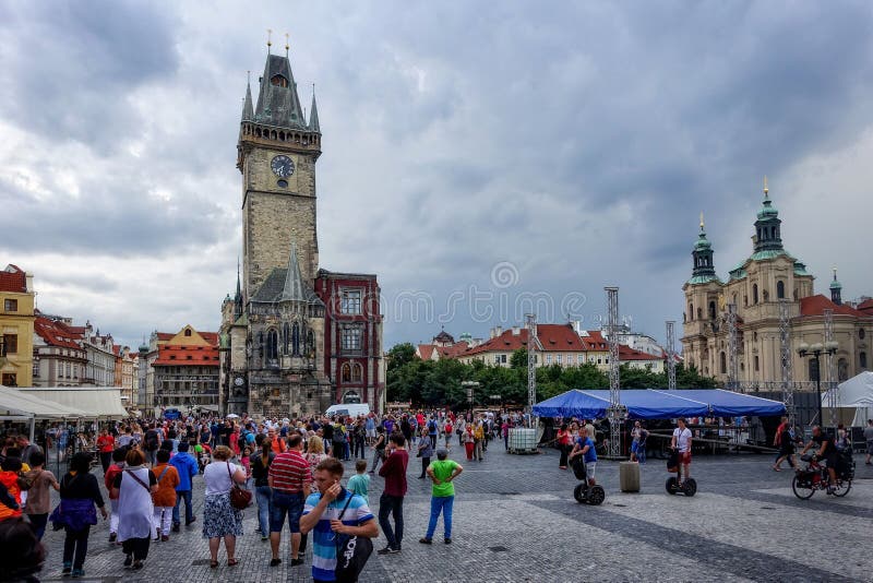 Tourists walking through Prague`s Old Town Square.