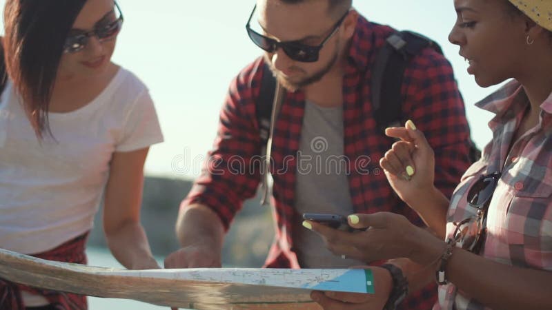 Tourists watching map while traveling stock video footage