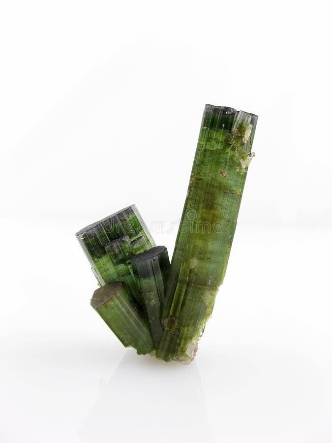 A group of green tourmaline crystals, variety verdelite, without matrix. Used in alternative medicine and crystal healing – a powerful electromagnetic crystal which energises the central nervous system (neuralgia and migraine) and is also associated with the heart chakra. It balances the left and right side of the brain promoting flexibility, compassion, objectivity and serenity. A group of green tourmaline crystals, variety verdelite, without matrix. Used in alternative medicine and crystal healing – a powerful electromagnetic crystal which energises the central nervous system (neuralgia and migraine) and is also associated with the heart chakra. It balances the left and right side of the brain promoting flexibility, compassion, objectivity and serenity.