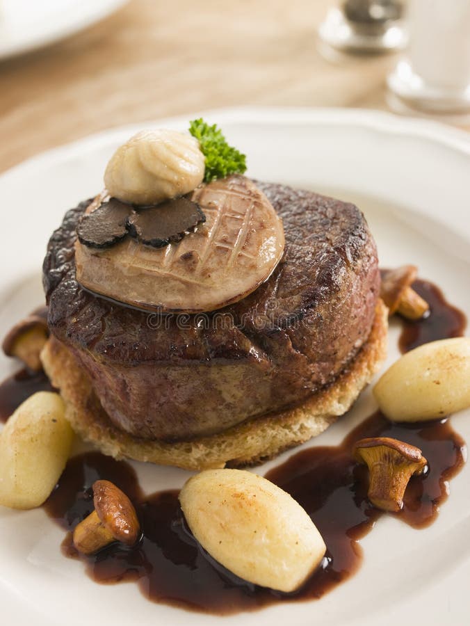 Tournedos Rossini with Cocotte Potatoes high angle view. Tournedos Rossini with Cocotte Potatoes high angle view