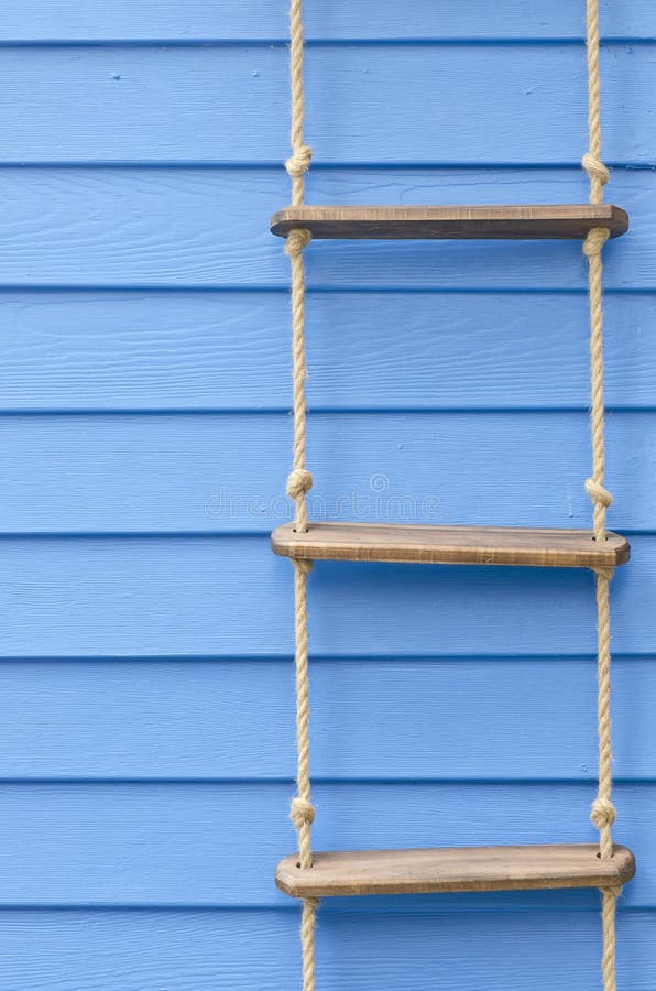 Rope ladder on the blue wall for background. Rope ladder on the blue wall for background.