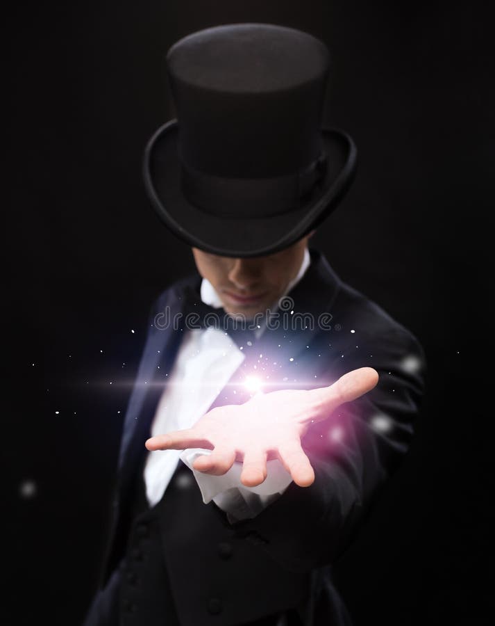 Magic, performance, circus, show and advertisement concept - magician holding something on palm of his hand. Magic, performance, circus, show and advertisement concept - magician holding something on palm of his hand