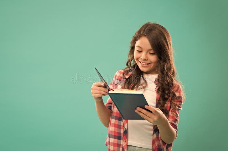 Towards knowledge. Girl hold book read story over blue background. Child enjoy study and reading book. Book store royalty free stock images Towards knowledge. Girl hold book read story over blue background. Child enjoy study and reading book. Book store royalty free stock images