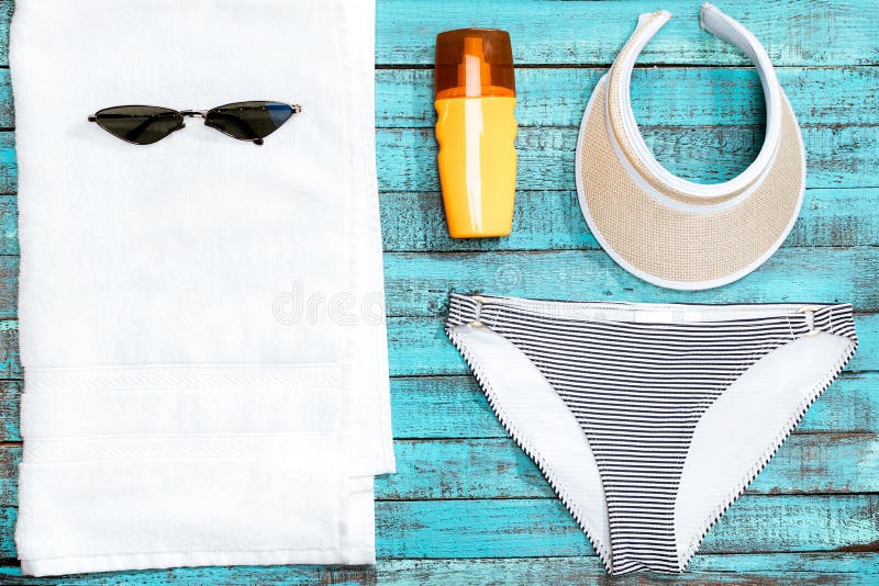 Towel, Swimming Pants, Sunglasses and Sun Cream on Table Stock Photo ...
