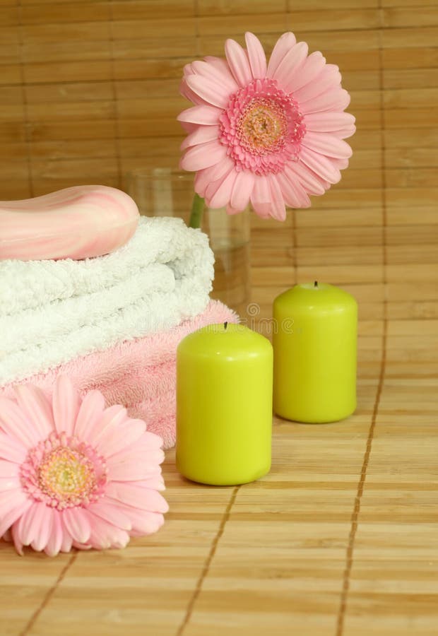 Towels, candles and pink gerber