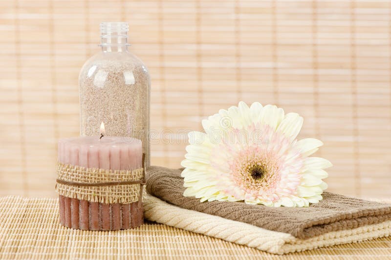 Towels, flower, candle and aromatic sand