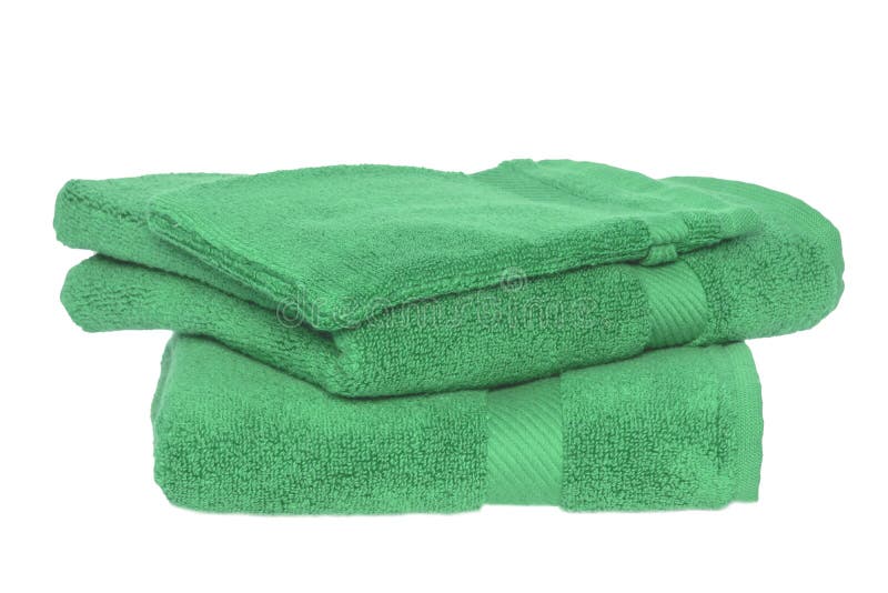 Towels isolated. Closeup of a stack or pile of green soft terry bath towels isolated on a white backgroun stock photos