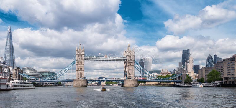 View from the thames river to the tower bridge on a cloudy day in london. ideal for websites and magazines layouts. View from the thames river to the tower bridge on a cloudy day in london. ideal for websites and magazines layouts