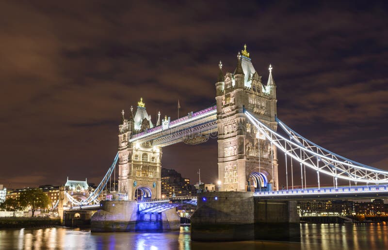 Tower Bridge seen from the docks at night in London, UK