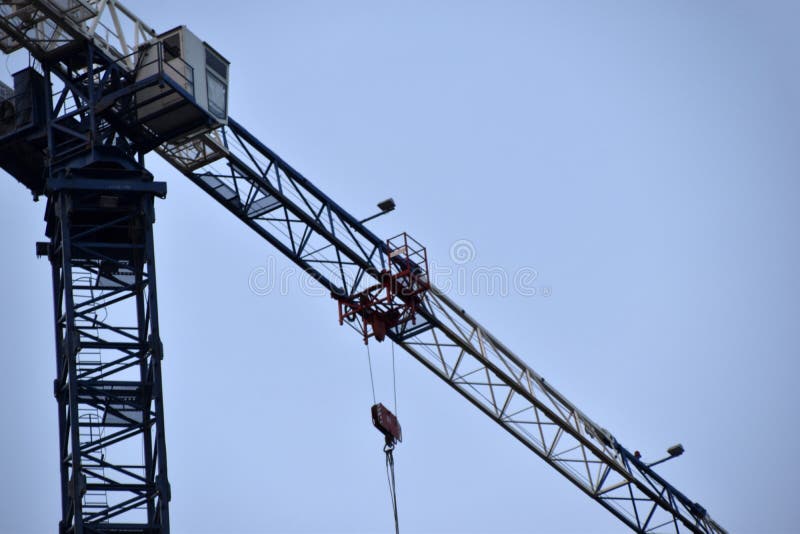 Tower Crane Near a House Under Construction in the City during the Day