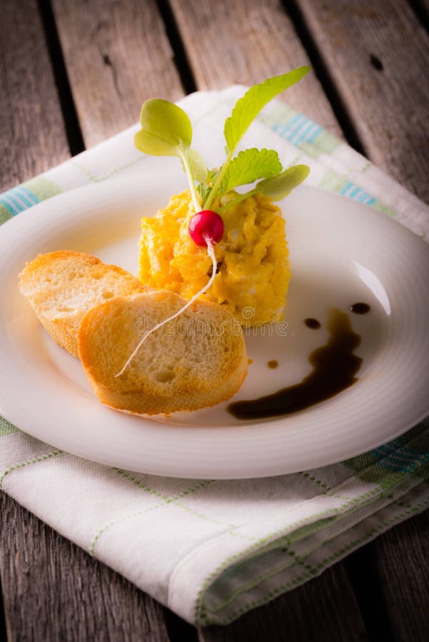 Scrambled egg in small cast-iron skillet. Making omelet eggs. Stock Photo  by ©boomeart 327353544