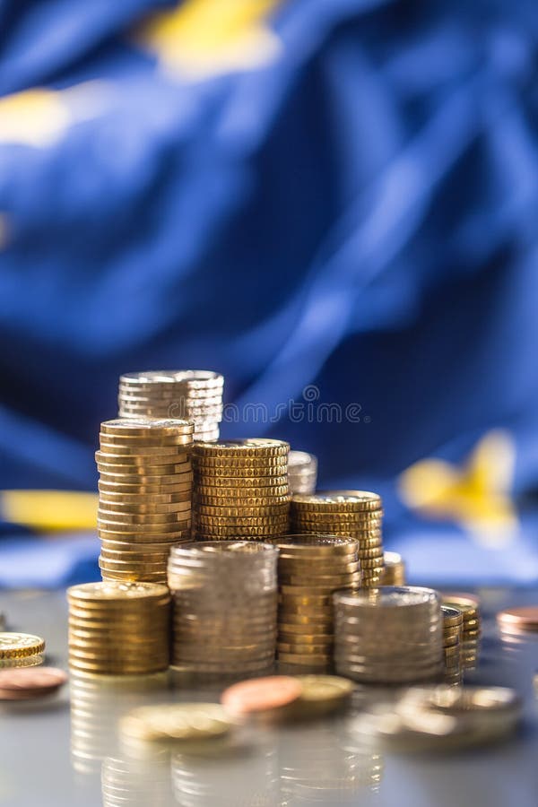 Towers with euro coins and flag of European Union in the background