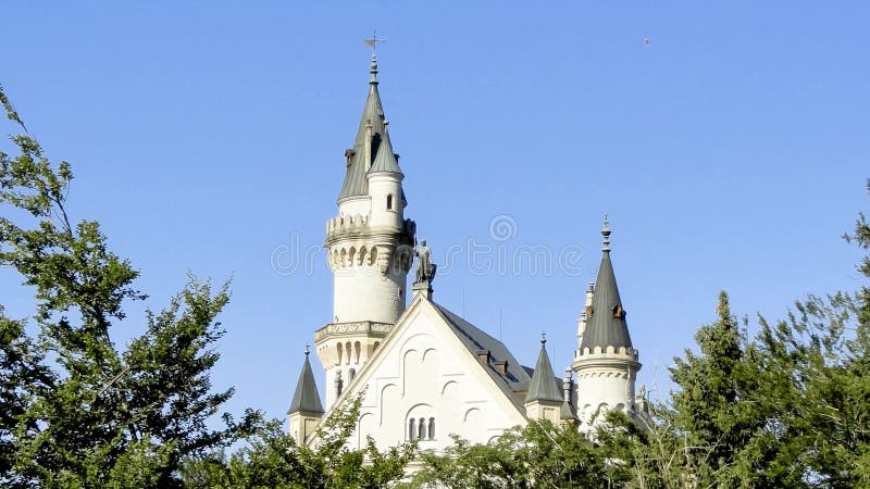 Towers of Neuschwanstein Castle with blue sky on background. Sunny summer view.