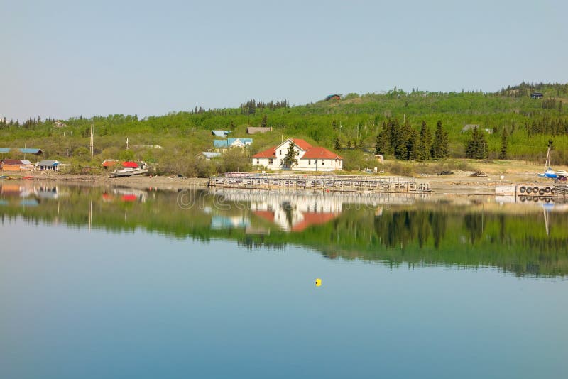 The town of atlin reflected in the early morning sun