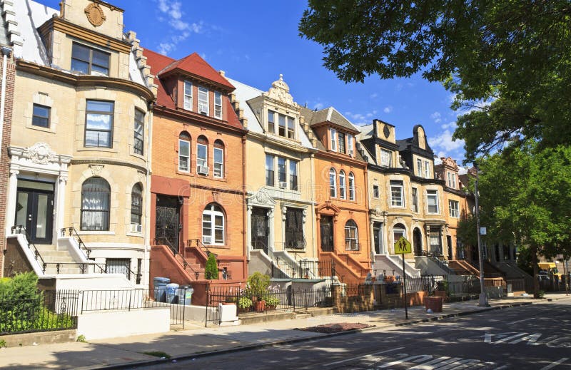 A row of unique townhouse apartment buildings with stoops on New York Ave. in the Crown Heights neighborhood of Brooklyn, NY. A row of unique townhouse apartment buildings with stoops on New York Ave. in the Crown Heights neighborhood of Brooklyn, NY