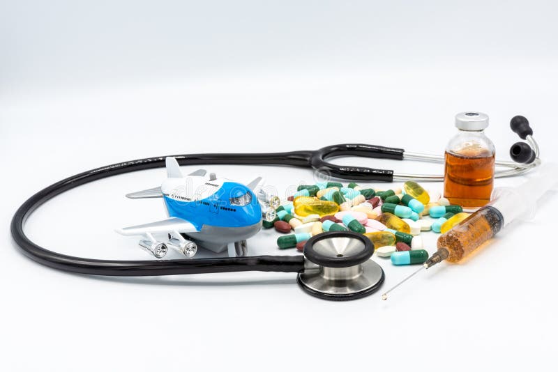 Toy airplane with black stethoscope and assorted drugs imply medical tourism on white black ground stock photography Toy airplane with black stethoscope and assorted drugs imply medical tourism on white black ground stock photography