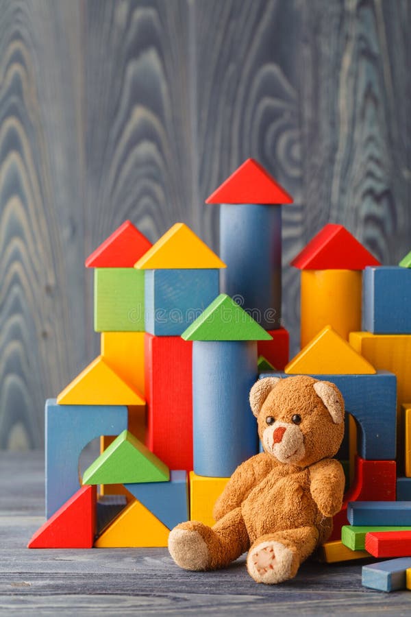 Toy bear and pile wooden building blocks
