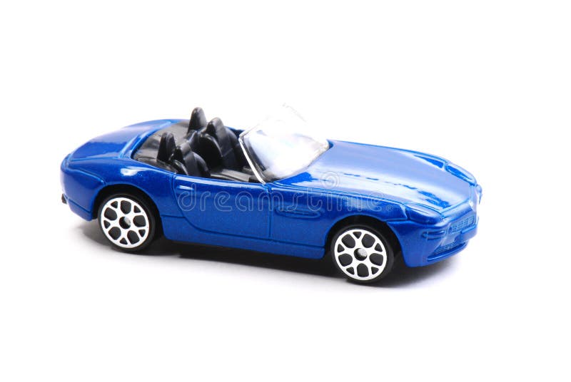 A blue painted toy convertible car against a white backdrop. A blue painted toy convertible car against a white backdrop.