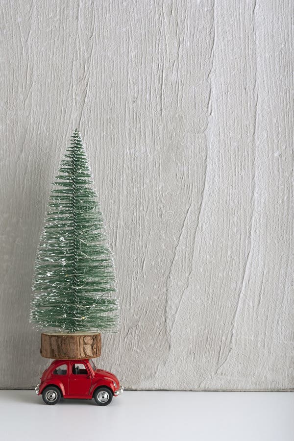 Toy Car with Christmas Tree on Roof. Car As Gift Under the Tree Stock