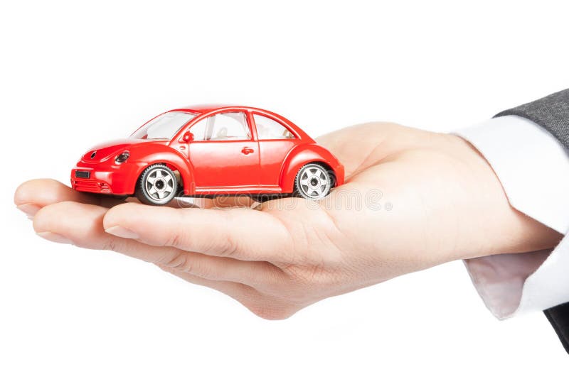Toy car in the hand of business man concept for insurance, buying, renting, fuel or service and repair costs
