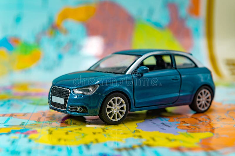 A toy car stands on a geographical map stock photo