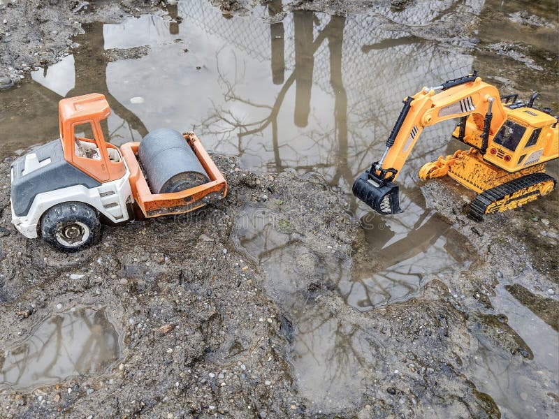 Toy Compactor and a Toy Excavator in the Mud Stock Image Image of