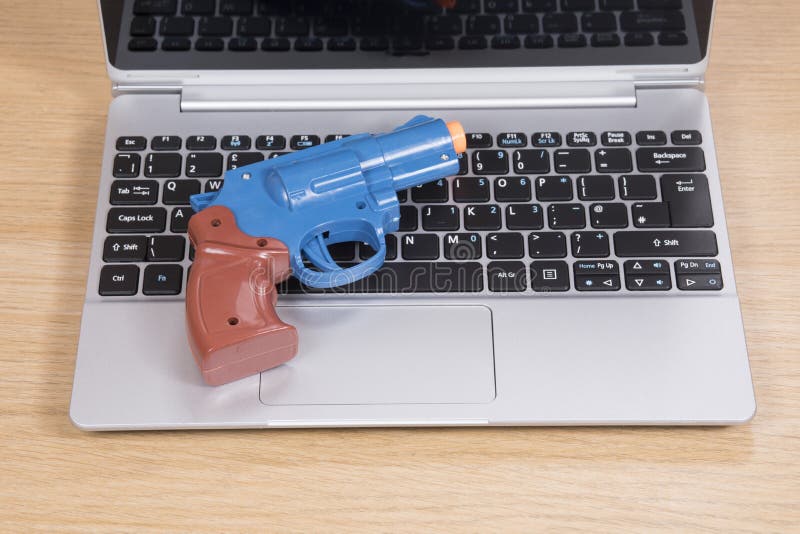 Toy Gun Lying on an Open Laptop Stock Photo Image of crime, handgun