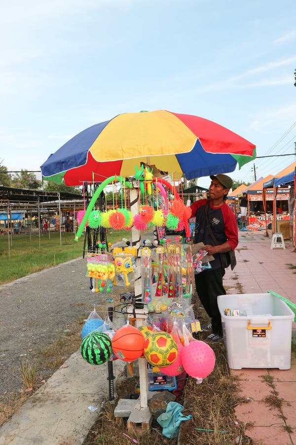 Cilacap, Indonesia March 16, 2023 : A toy seller is arranging various toys to sell to children visiting the city park