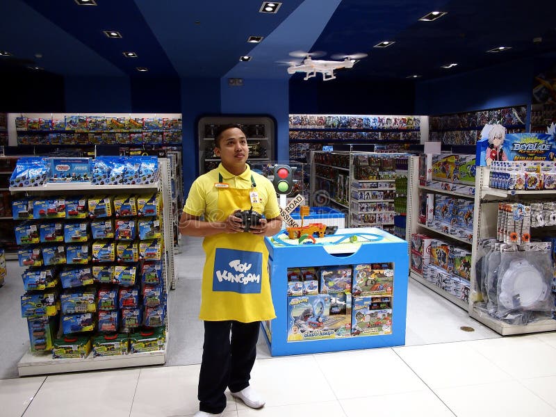 MANDALUYONG CITY, PHILIPPINES - JULY 22, 2017: A toy store employee demonstrates how to fly a toy drone.