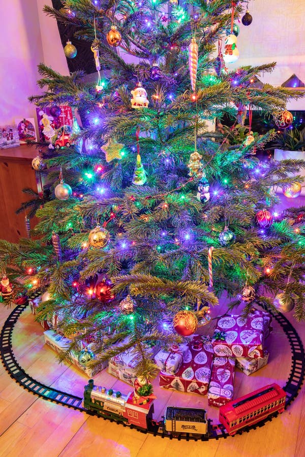 A Toy Train and Presents Under a Christmas Tree Stock Photo Image of