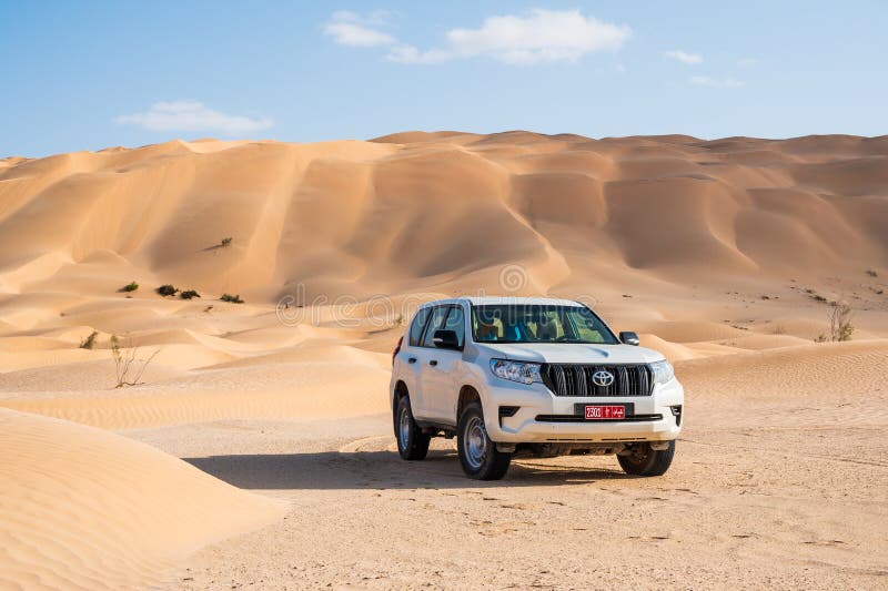 Toyota Prado 4x4 car with high sand dunes behind stock image Toyota Prado 4x4 car with high sand dunes behind stock image