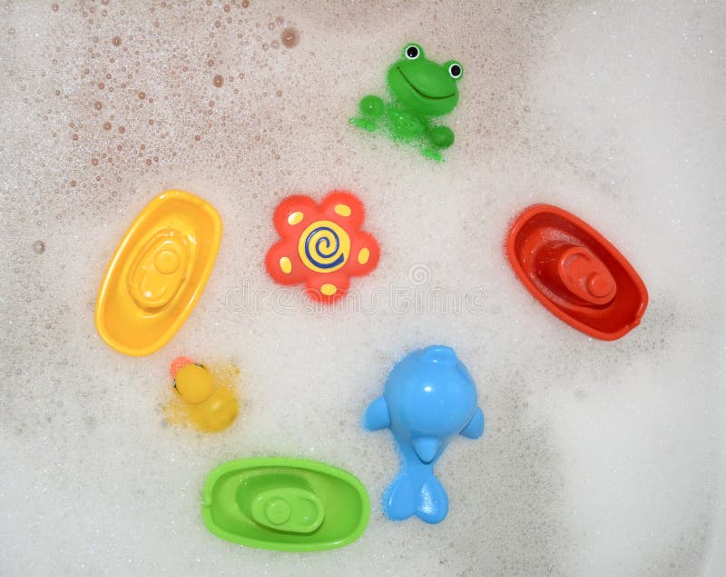 Toys floating in the bath with foam royalty free stock photo Toys floating in the bath with foam royalty free stock photo