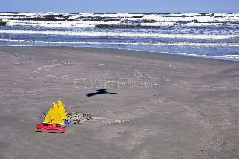 Toys sail boats on beach