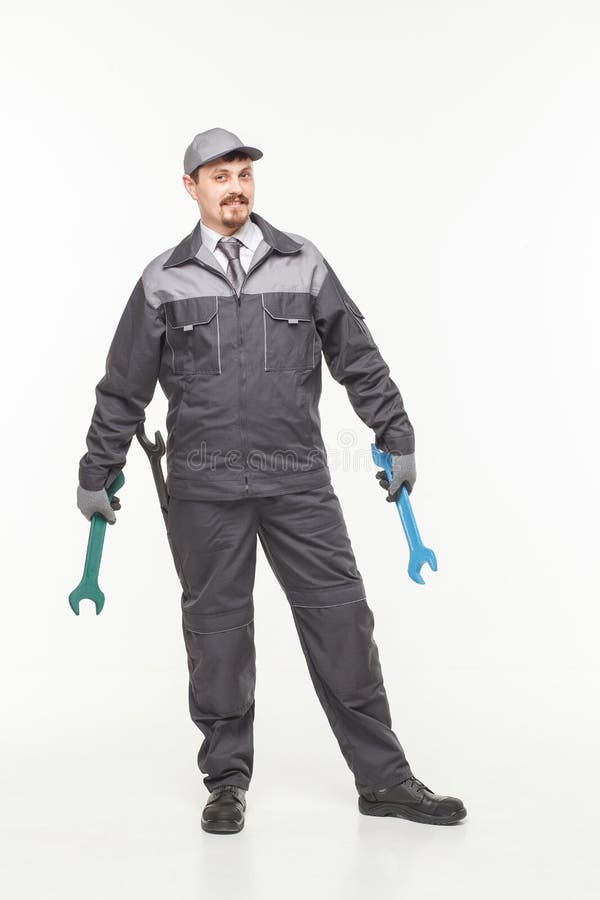 Trabajador en uniforme con la llave fotografía de archivo libre de regalías Trabajador en uniforme con la llave fotografía de archivo libre de regalías