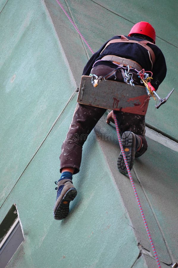 Construction worker working high on a wall. Construction worker working high on a wall