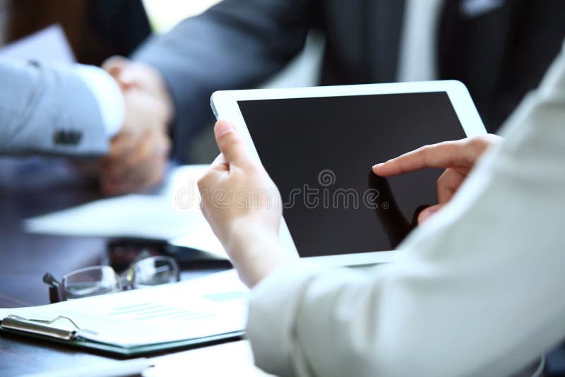 Close-up image of an office worker using a touchpad to analyze statistical data. Close-up image of an office worker using a touchpad to analyze statistical data