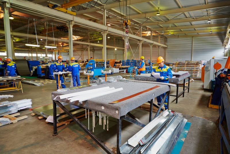 LOBNYA - JUN 7: Workers in manufacturing workshop at plant of Group of companies Metal Profile, June 7, 2012, Lobnya, Russia. Structure of Group of companies Metal Profile includes 12 plants. LOBNYA - JUN 7: Workers in manufacturing workshop at plant of Group of companies Metal Profile, June 7, 2012, Lobnya, Russia. Structure of Group of companies Metal Profile includes 12 plants.