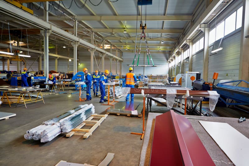 LOBNYA - JUN 7: Workers in manufacturing workshop at plant of Group of companies Metal Profile, June 7, 2012, Lobnya, Russia. Structure of Group of companies Metal Profile includes 12 plants. LOBNYA - JUN 7: Workers in manufacturing workshop at plant of Group of companies Metal Profile, June 7, 2012, Lobnya, Russia. Structure of Group of companies Metal Profile includes 12 plants.