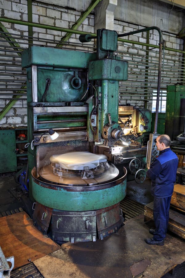 Trabalhe o metal de observação do processo que trabalha em máquinas de giro verticais imagens de stock Trabalhe o metal de observação do processo que trabalha em máquinas de giro verticais imagens de stock