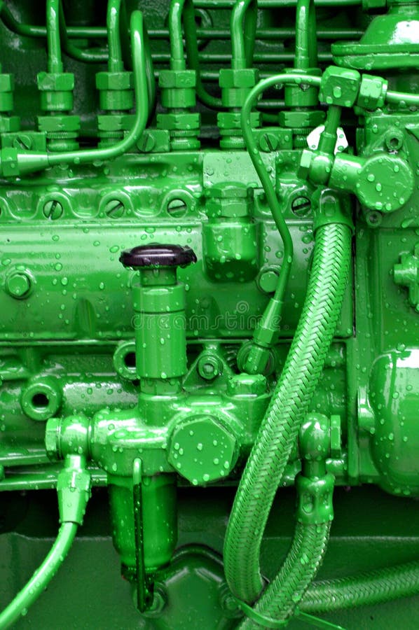 Green colored pipes and wires on a tractor engine