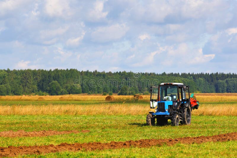 Tractor on a farmer field stock photos