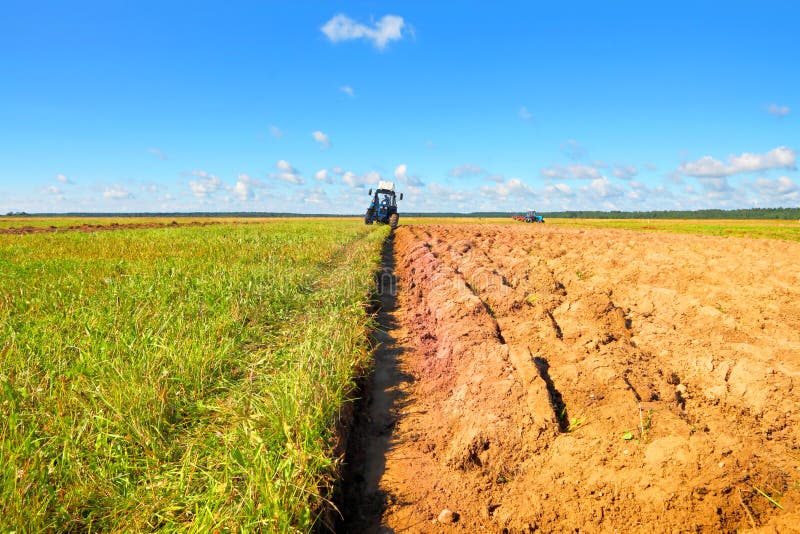 Tractor on a farmer field royalty free stock image