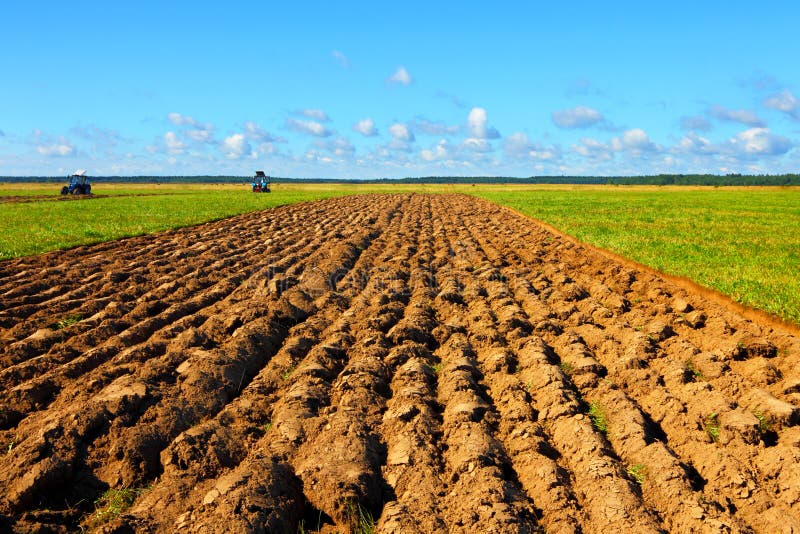 Tractor on a farmer field royalty free stock image