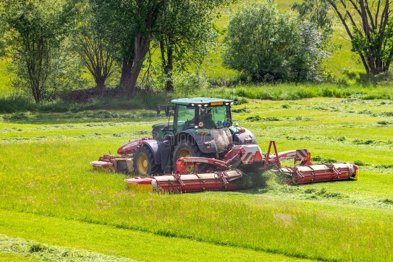 Tractor on Green Meadow Cuts Grass Stock Image Image of outdoors