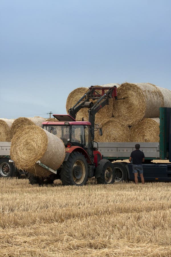 Tractor moving bales